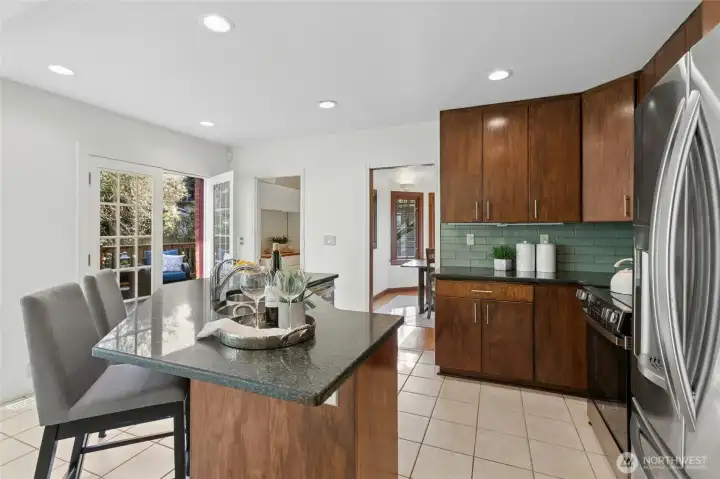 Kitchen island is big enough for casual dining. Under counter power outlets in island extend your options for food prep space too. Dining room, walk-in-pantry, and deck are all accessible from this area.