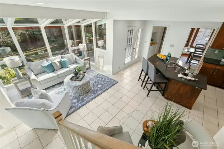 What a wonderful flow to this floor plan! Walls of glass and French doors opening to deck perfectly connect this indoor comfort with the beauty of nature outside.