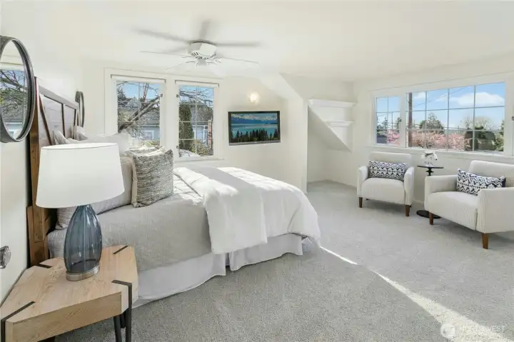 Spacious upper level primary suite has brand new wall-to-wall carpet and ceiling fan.