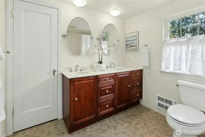 Upper level bathroom has duel sink vanity and large linen closet.