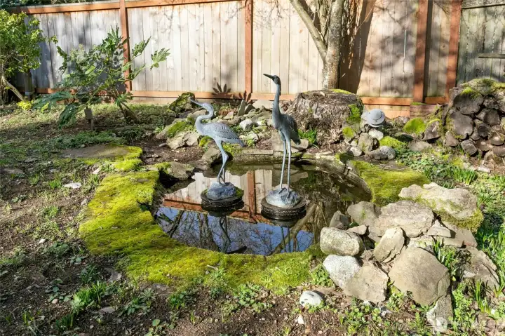 Crane statues stay with this reflecting pool.