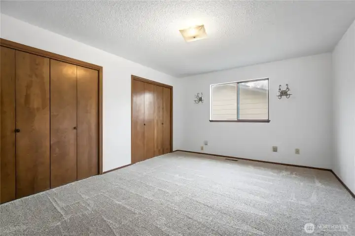 Main Level Primary Suite - Comfortable bedroom with fresh finishes, natural light, and room to relax.