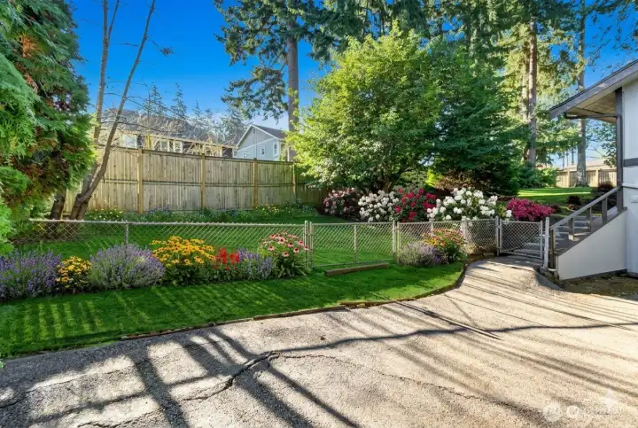 Fully fenced, level & sunny backyard.