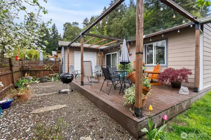 Fully fenced side yard with gardening space and mature landscaping. Ready for your favorite flowers or veggies!