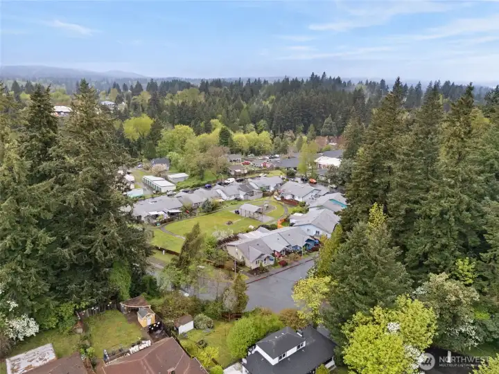 Peaceful neighborhood setting with central green space and well maintained surroundings.