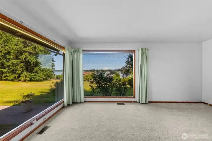Primary bedroom w floor to ceiling windows Primary bedroom w floor to ceiling windows