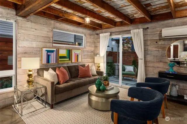 Complementary hues of wood are found in almost every structural detail of the home and exposed wood beams create a dramatic ceiling for the main living level. The concrete flooring adds a fresh, modern touch but vintage fixtures, such as thick reclaimed doors, add distinct character.