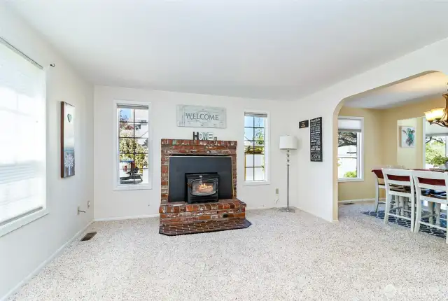 Formal Living Room~Real Brick Fireplace & Hearth with a Wood Burning Insert~North Facing & Easily Flows into Arched Dining Room Entry~