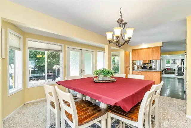 Dining Room Overlooks the Back Yard thru a Wall of Windows~French Doors lead to the Expansive Yard & Patio~