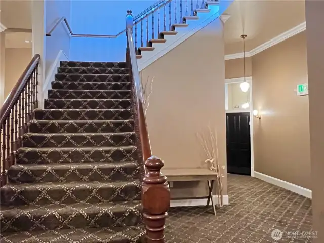3rd floor landing with elegant staircase to the 4th floor and door to end condo unit 302.