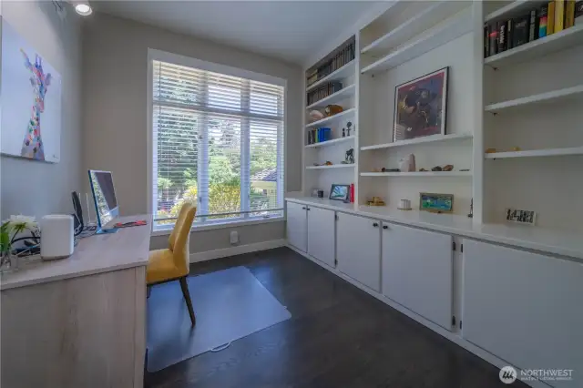 Main floor den with built-ins and double door entry.