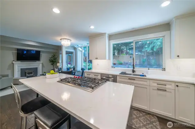 Great view of the breakfast bar island and the adjacent family room.