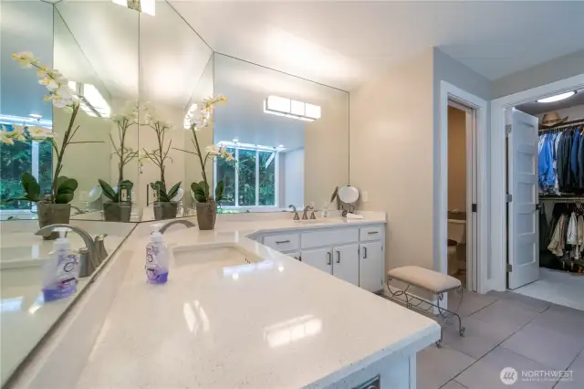 Remodeled spa-like primary bath features dual vanity, walk-in shower, soaking tub, walk-in closet, updated lighting flooring and more.