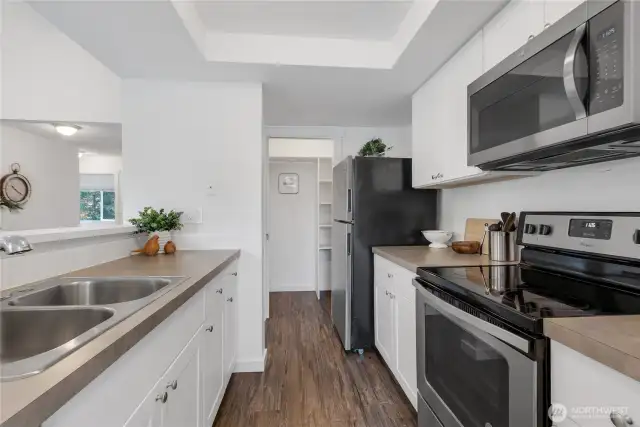 The other end of the kitchen has a large walk in pantry!