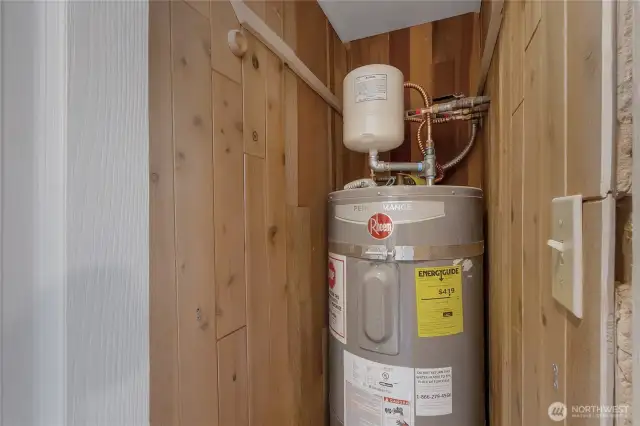 Newer Water heater with required pan and seismic straps, located in a closet near the front door.
