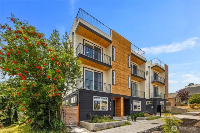 Set back from the street with a private entry, this end-unit townhouse offers a gated side yard, lush garden beds, and a quiet sense of separation from the bustle.