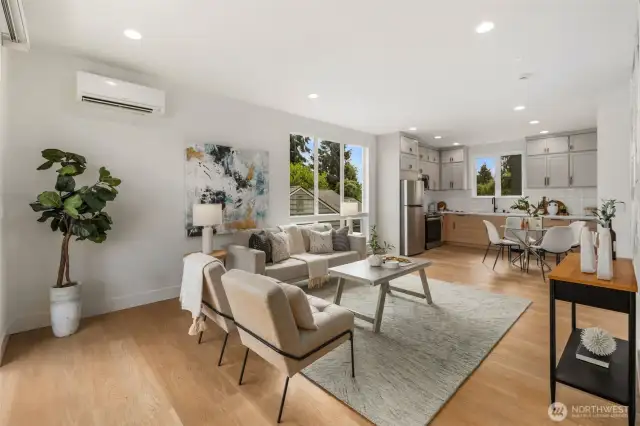 High ceilings, recessed lighting, and a harmonious palette of light-toned walls and floors create a bright, airy feel, while ductless mini-splits provide efficient heating and cooling year-round.