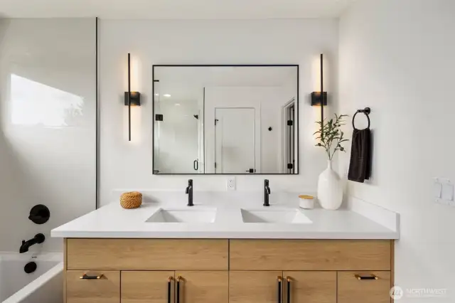 Sleek and functional, the double-sink vanity offers generous cabinet space, modern vertical lighting, and a huge mirror—perfect for two to get ready in comfort and style.