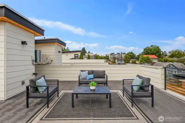 Modern tile flooring and sleek railing give the space a clean, contemporary feel that complements the open-air setting.