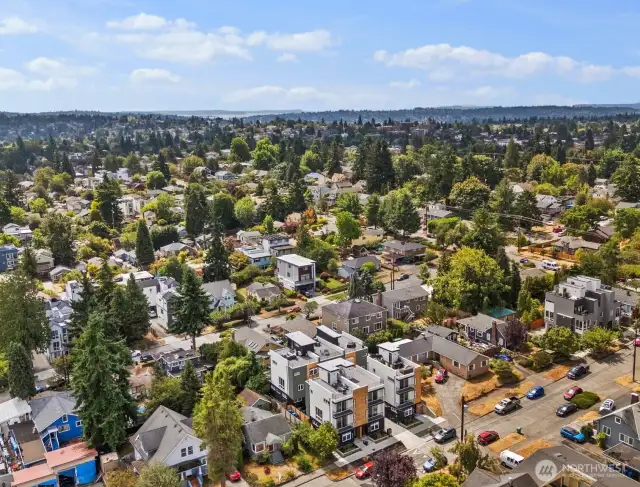 This southwesterly view captures the home in the foreground, with Ballard’s vibrant streets and the sparkling waters of Shilshole Bay stretching out in the distance. It’s a setting that blends neighborhood charm with a glimpse of Puget Sound beauty.