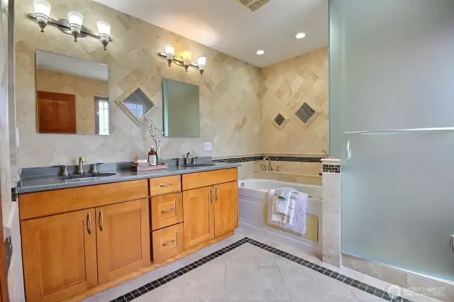 Beautiful primary bath with walk-in shower and jacuzzi tub.