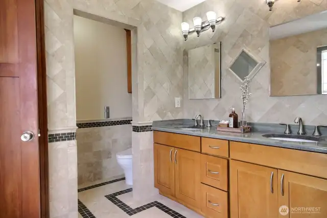Bath features dual sink vanity and private toilet closet.