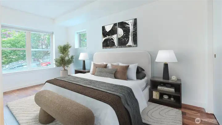 Bright and inviting bedroom featuring large windows.