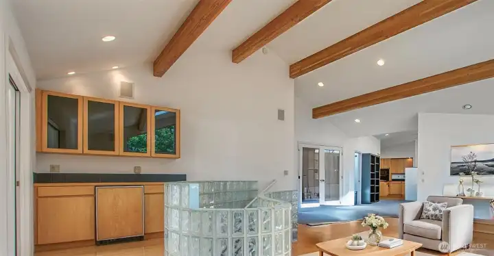 The wet bar, perfect for parties, at the left is near the stair to the lower floor. Double doors are the foyer