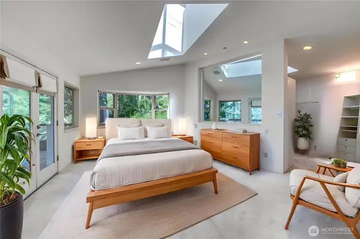 The contemporary primary bedroom offers a spacious oasis for the new owner
