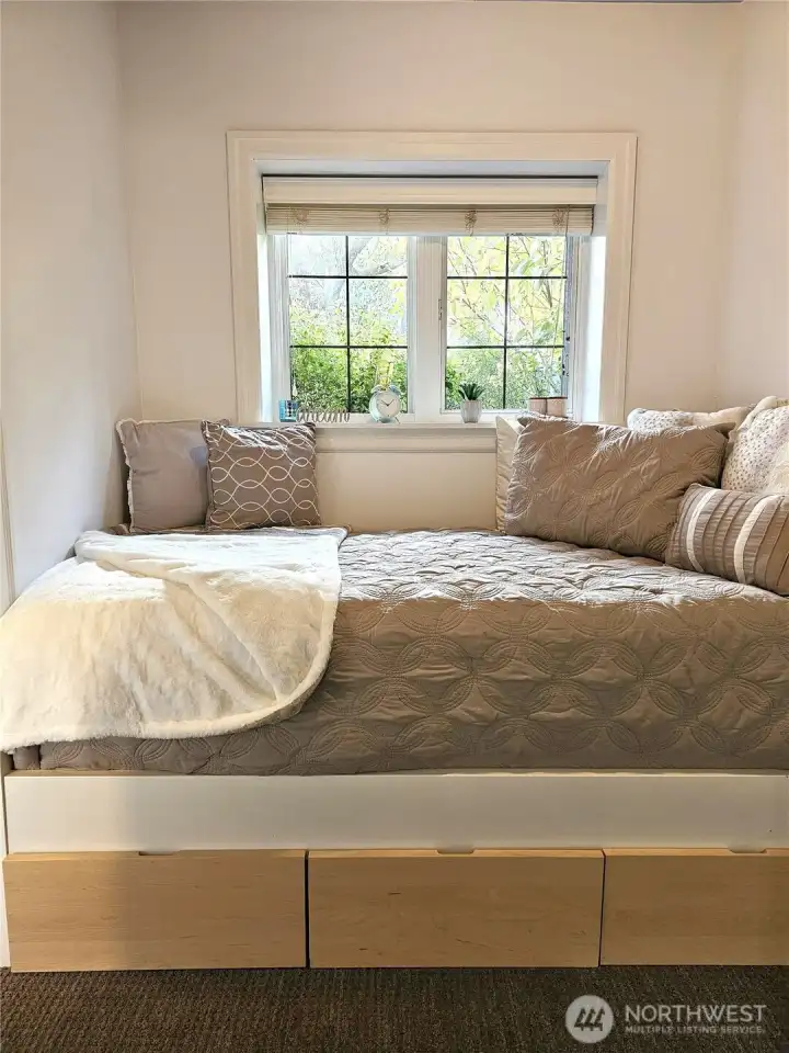 The decorative daybed with storage fits this space like a glove and is included in the sale.