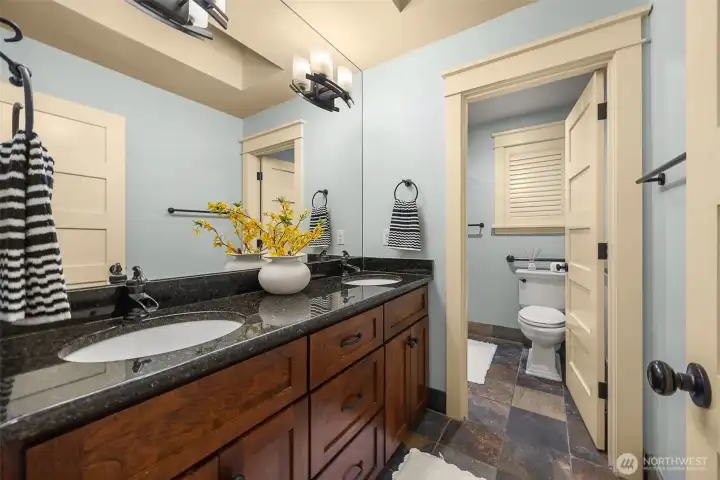 Another full bath in the upper level with an additional private door and custom shutters