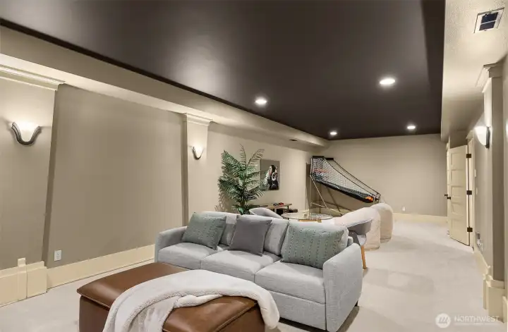 A separate private open theater or game room on the lower level