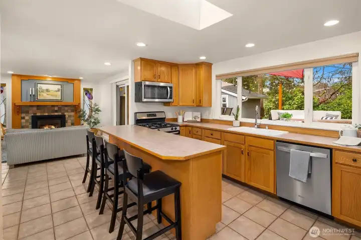 Eat-in kitchen with gas stove and all stainless appliances.