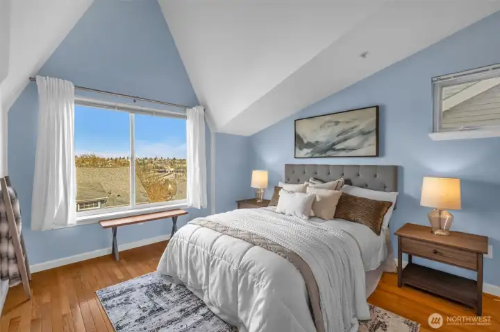 Primary bedroom with vaulted ceilings