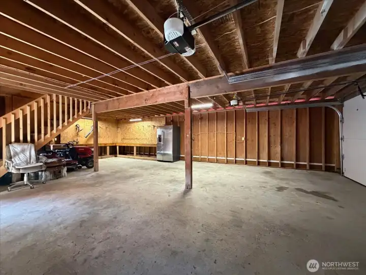 The main garage space with workshop area extended in the back area.