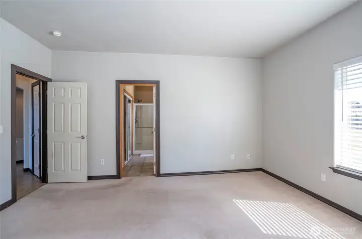 Additional view of the bright primary suite featuring a private ensuite bathroom.
