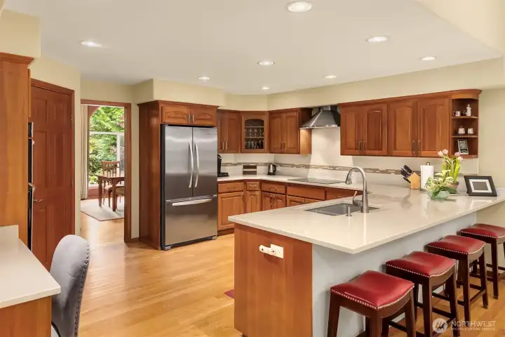 The kitchen features custom cabinetry, a walk-in pantry (not shown) and stainless steel appliances.