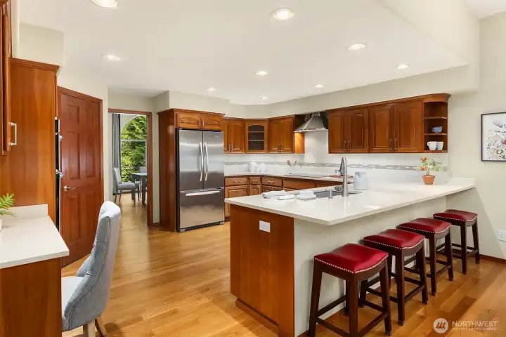 The kitchen features custom cabinetry, a walk-in pantry (not shown) and stainless steel appliances.