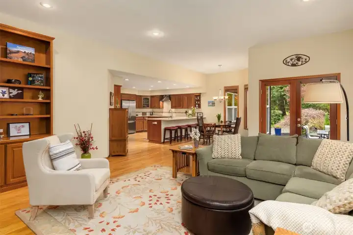 A generous family room with built-in bookshelves adjoins the kitchen and breakfast area, and has French doors leading to a patio.