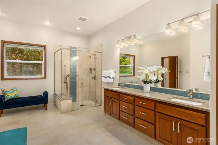 The renovated bathroom features a curbless shower and radiant heated stone floor.