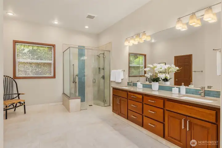 The renovated bathroom features a curbless shower and radiant heated stone floor.