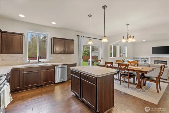 View of Kitchen and Kitchen Island Overlooking the Dining Area and Living Room