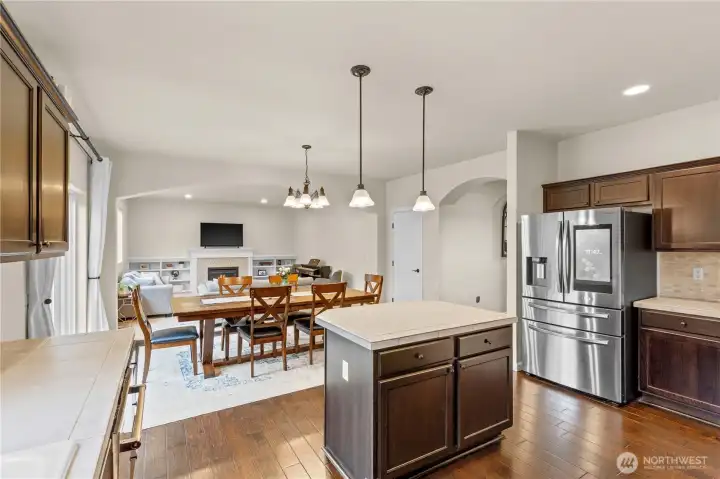 View of Kitchen and Kitchen Island Overlooking the Dining Area and Living Room