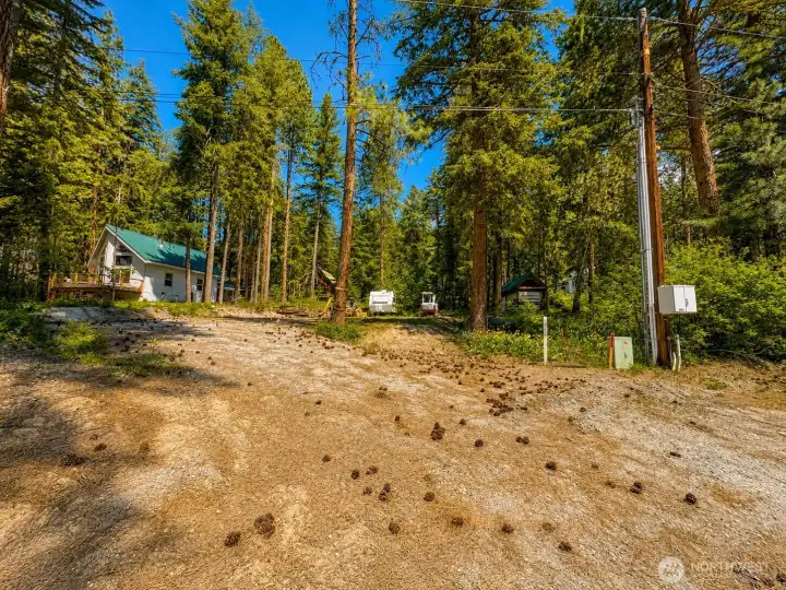 Beautiful forested setting with a welcoming sense of arrival and abundant natural beauty. The gently open landscape provides a versatile outdoor space while maintaining the privacy and charm of mountain living.