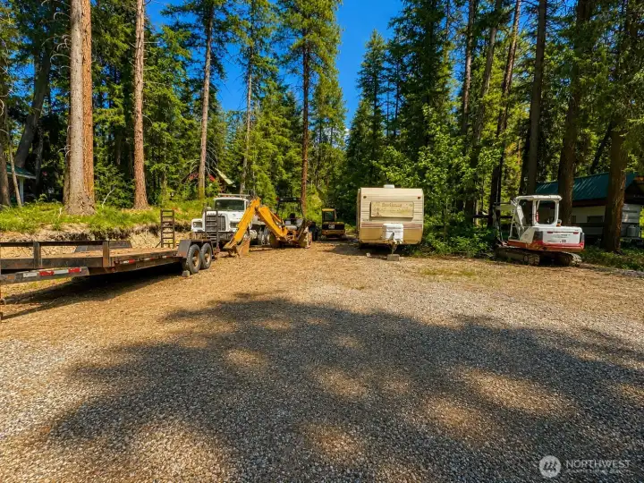 Expansive gravel access area with mature trees and excellent usability, ideal for mountain living and recreational convenience. The natural surroundings create a peaceful environment with authentic Pacific Northwest character.