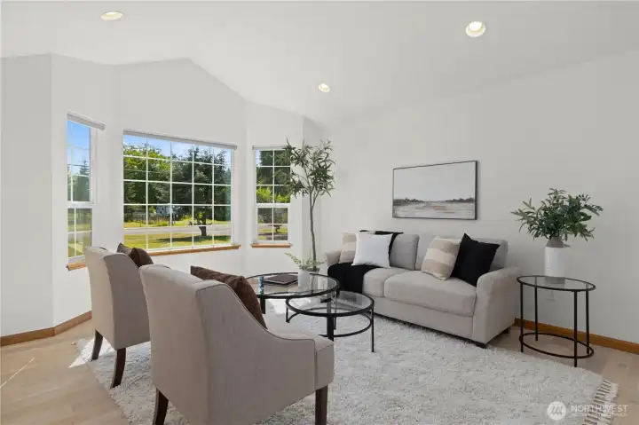 A separate living room or den with a vaulted ceiling and large windows overlooking the front. A separate living room or den with a vaulted ceiling and large windows overlooking the front.