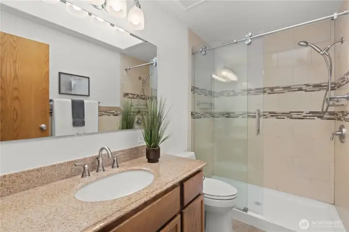 Guest 3/4 bath with tile surround and glass shower doors. Guest 3/4 bath with tile surround and glass shower doors.