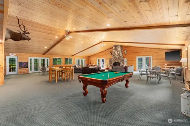 This must be where the term "Great Room" got it's name...Pool Table, 76" corner TV screen, seating for huge parties, fireplace two adjacent decks with multiple french door acesss, piano, an adjacent private prep room and more...