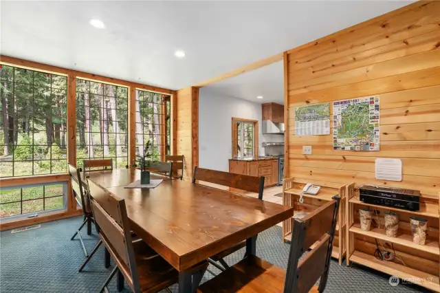 Across from the living room and dining area is another large dining table adjacent to the kitchen entry to accommodate the early morning breakfast crowd