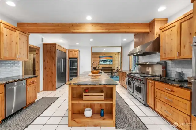 This Chef's envy kitchen also boasts tons of rich textured granite, two deep well sinks with stainless Dacor dishwashers, a commercial size refrigerator/freezer and a 15 rack wine cooler